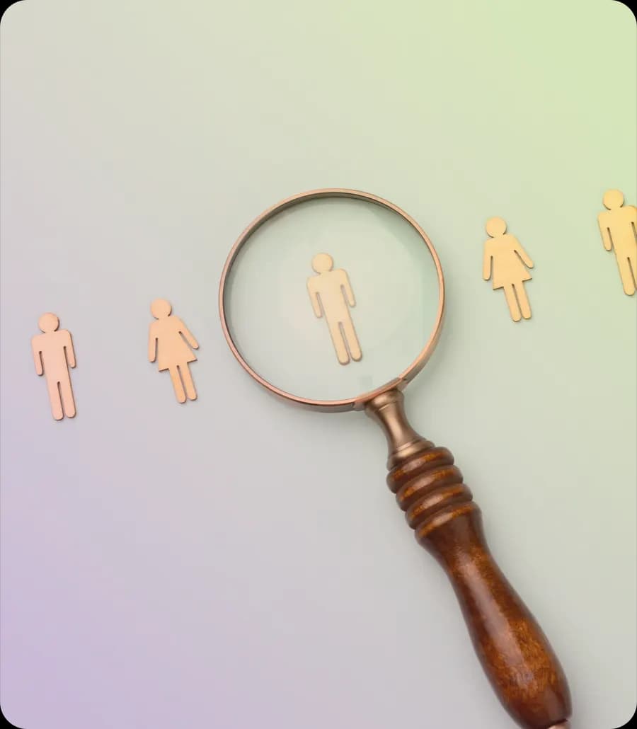 A magnifying glass held over a row of small figures